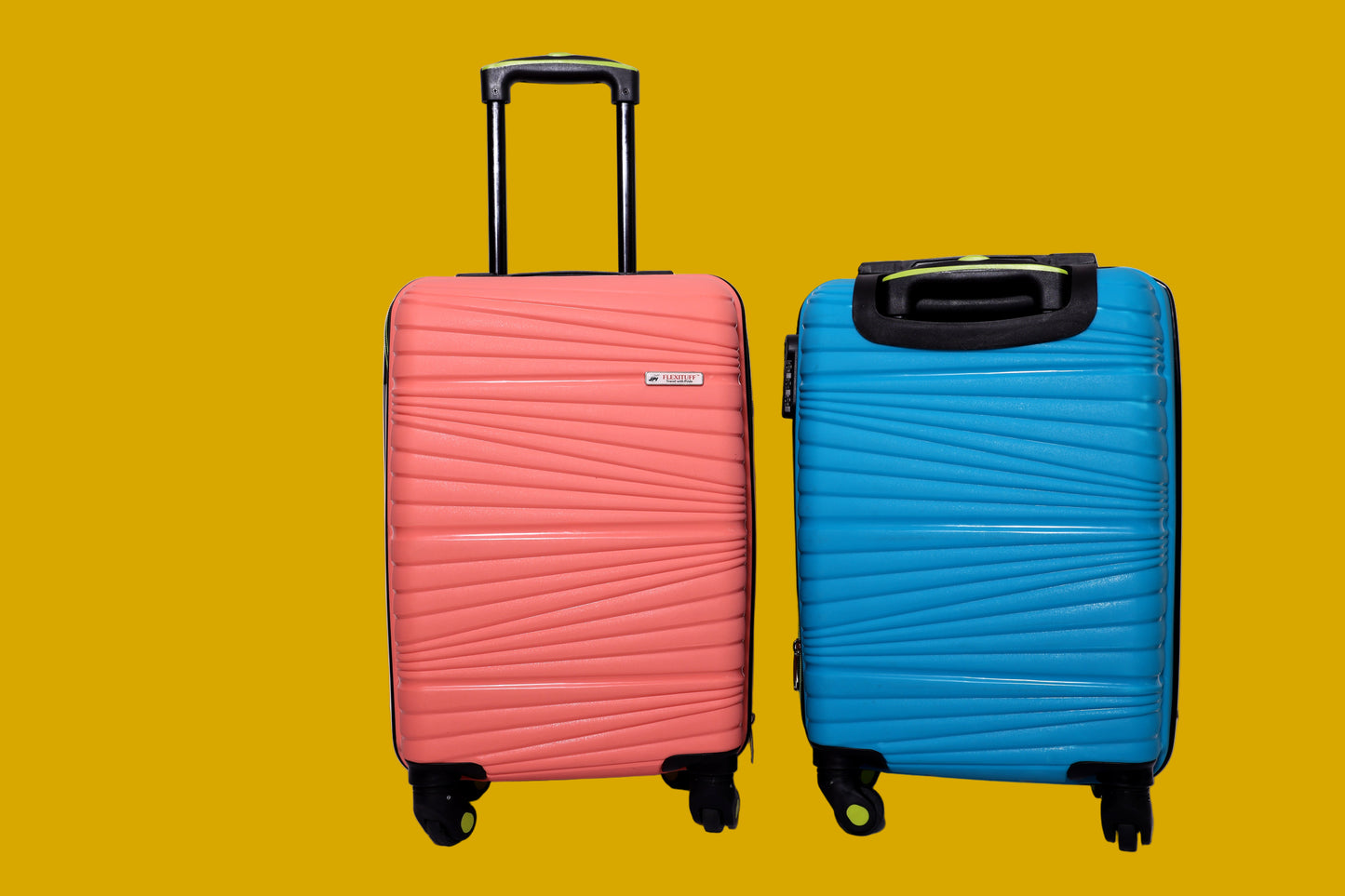 Two suitcases with trolley, one pink and one blue, on a mustard background.