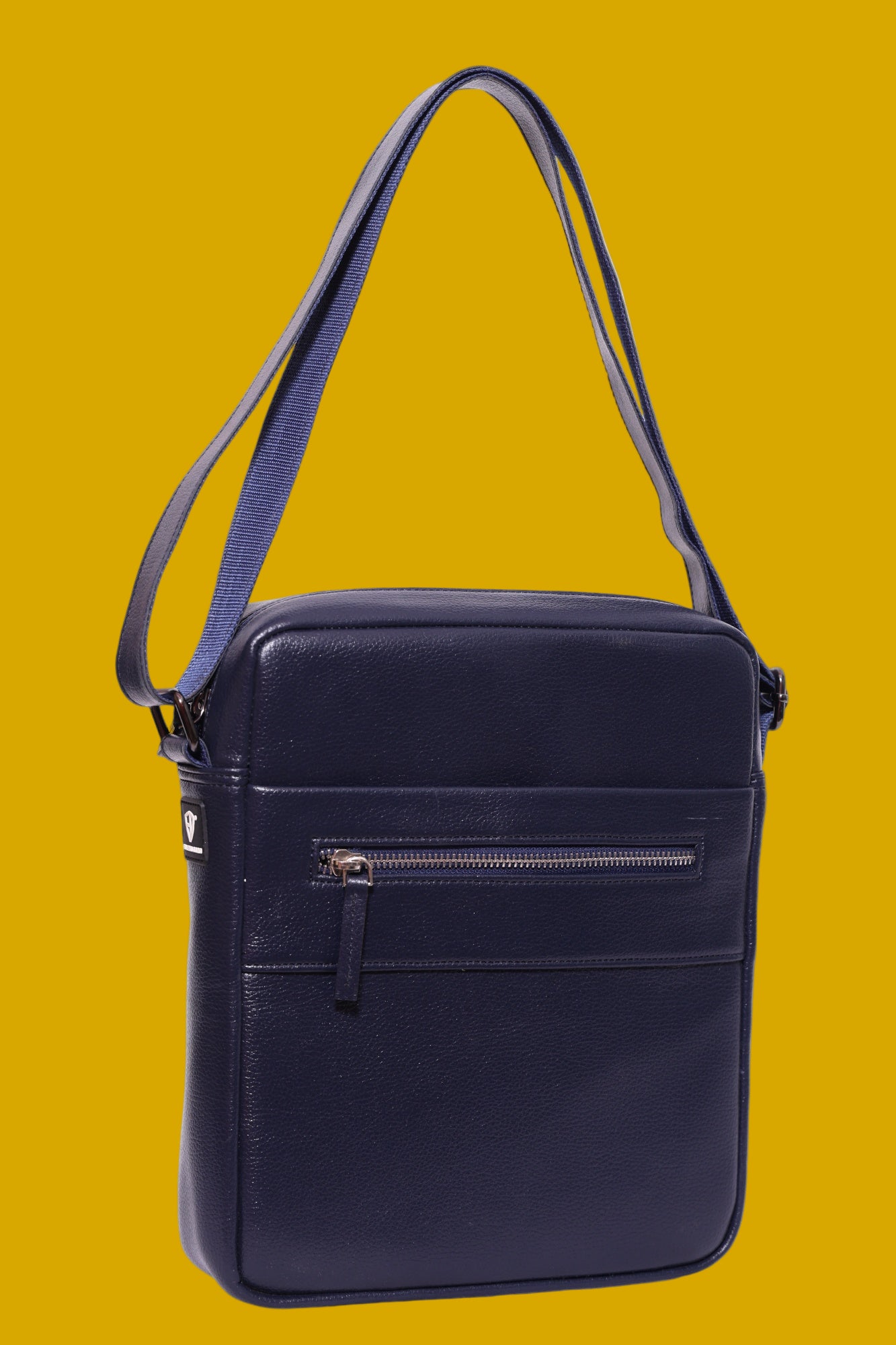 Navy blue vegan, leatherette  crossbody bag on a mustard background