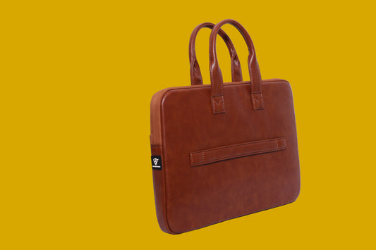 Brown leatherette sleeve bag on a mustard background